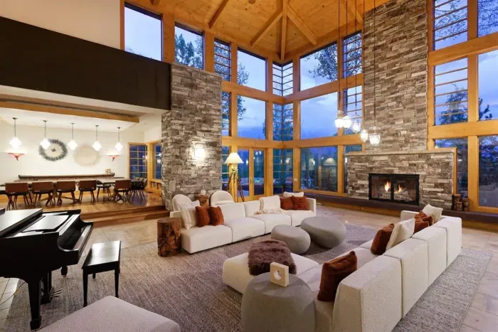 Gorgeous great room with 25 foot cherry ceilings, stone fireplace, and floor-to-ceiling windows.
