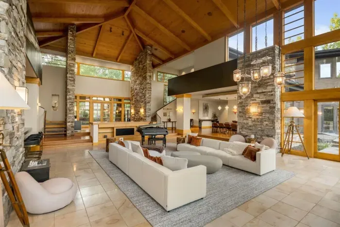 Gorgeous great room with 25 foot cherry ceilings, stone fireplace, and floor-to-ceiling windows.