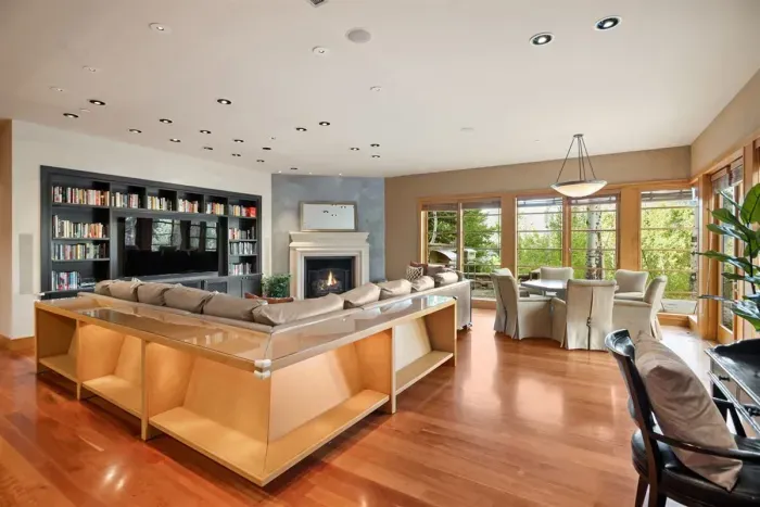Family room with TV, fireplace, and breakfast table attached to the kitchen with access to the backyard, grill, and pizza kitchen.