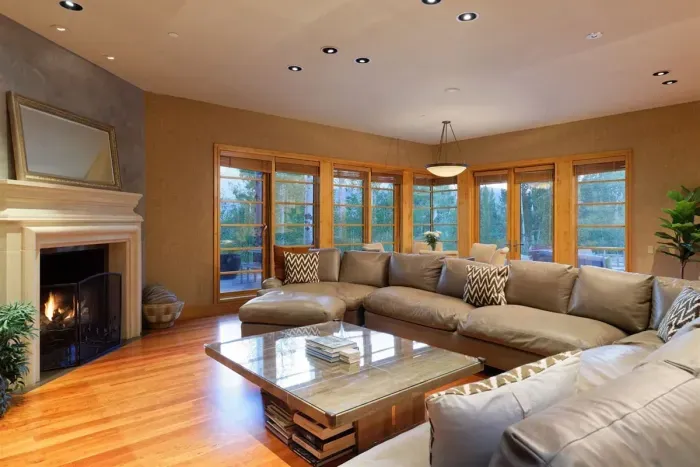Family room connected to the kitchen area with breakfast table, fireplace, and TV.