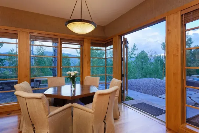 Main floor great room breakfast table with indoor/outdoor access.