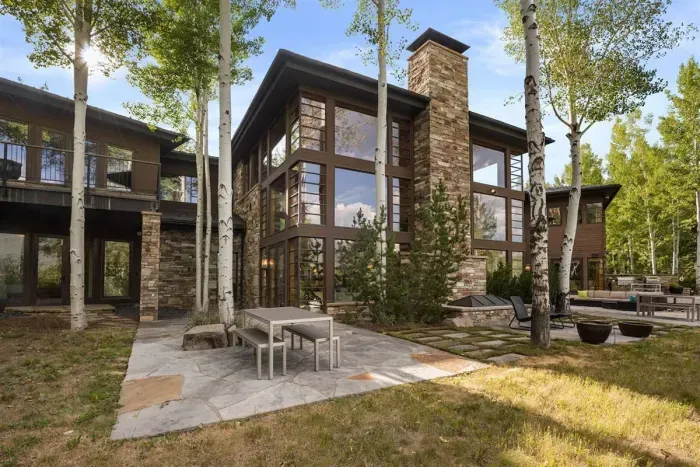 Large yard with multiple relaxation nooks surrounded by aspens.