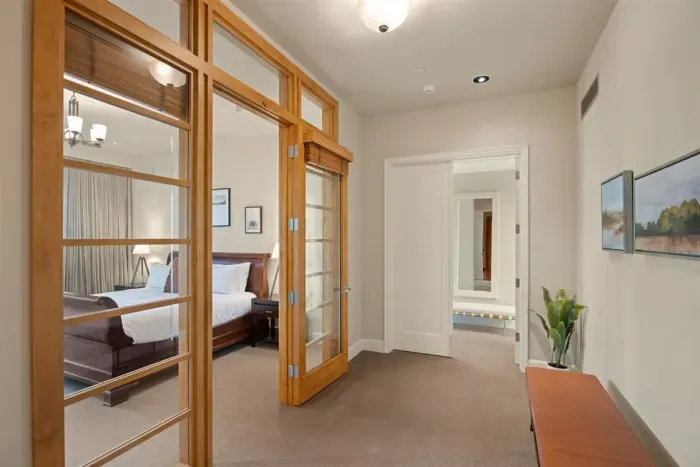 Wing 1 hallway to bedroom 4 (with glass doors) and entry to bedroom 2