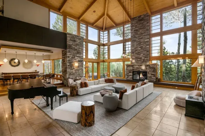 Gorgeous great room with 25 foot cherry ceilings, stone fireplace, and floor-to-ceiling windows.