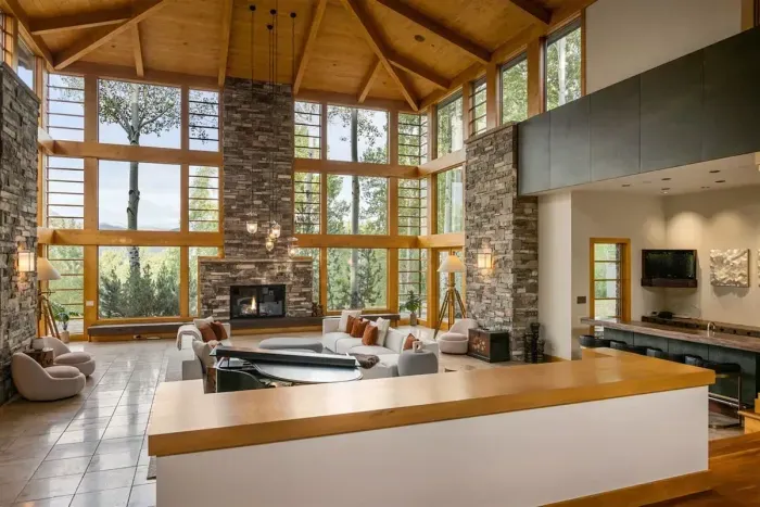 Gorgeous great room with 25 foot cherry ceilings, stone fireplace, and floor-to-ceiling windows.