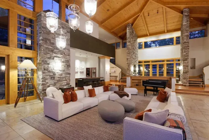 Gorgeous great room with 25 foot cherry ceilings, stone fireplace, and floor-to-ceiling windows.