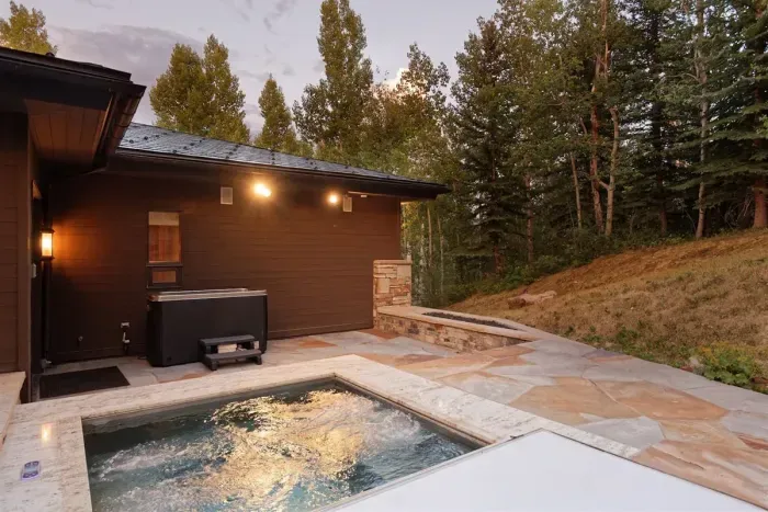Hot tub and cold plunge connected to the first wing primary bedroom.